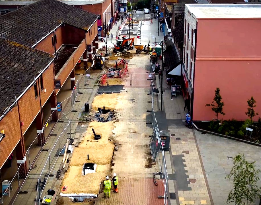The street with the carriageway broken out and services exposed