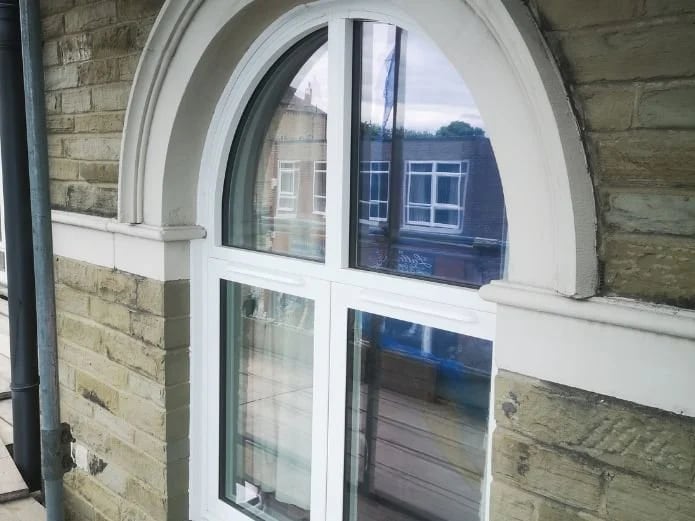 An arched window replaced to match the listed building