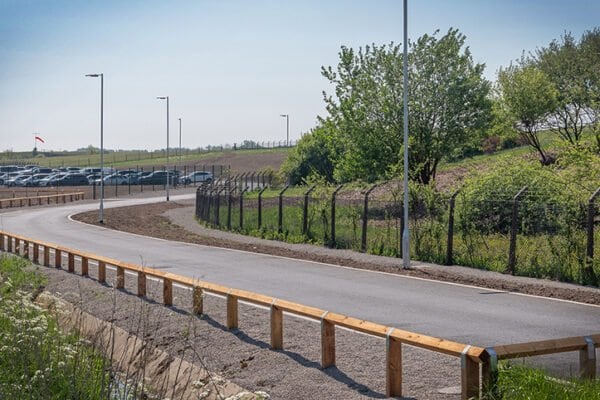 New access road and fencing at the edge of the car park
